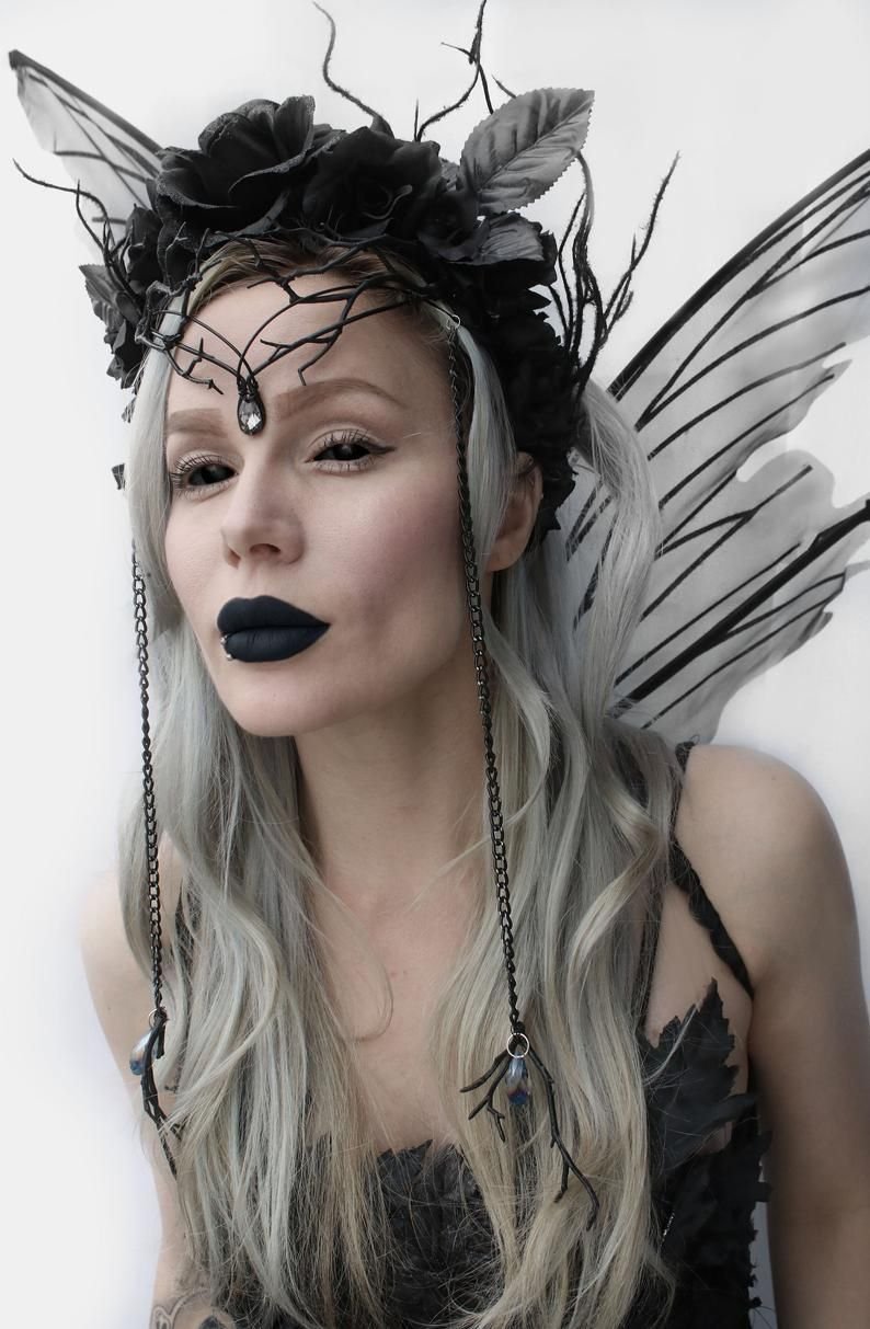 Woman in a dark fairy Halloween costume with wings