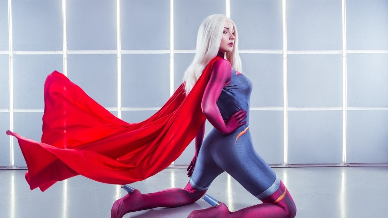 Woman in a superhero cosplay costume with cape