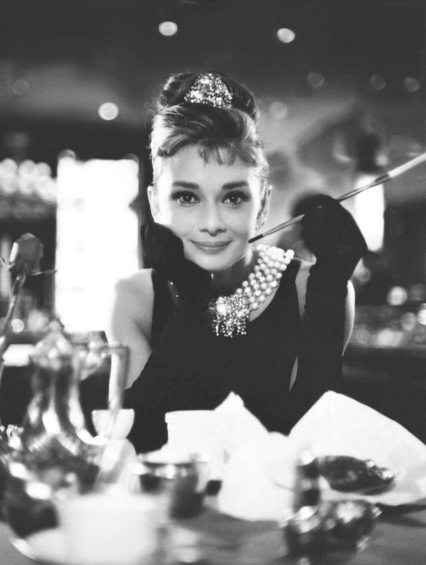 Woman in an Audrey Hepburn Holly Golightly Halloween costume