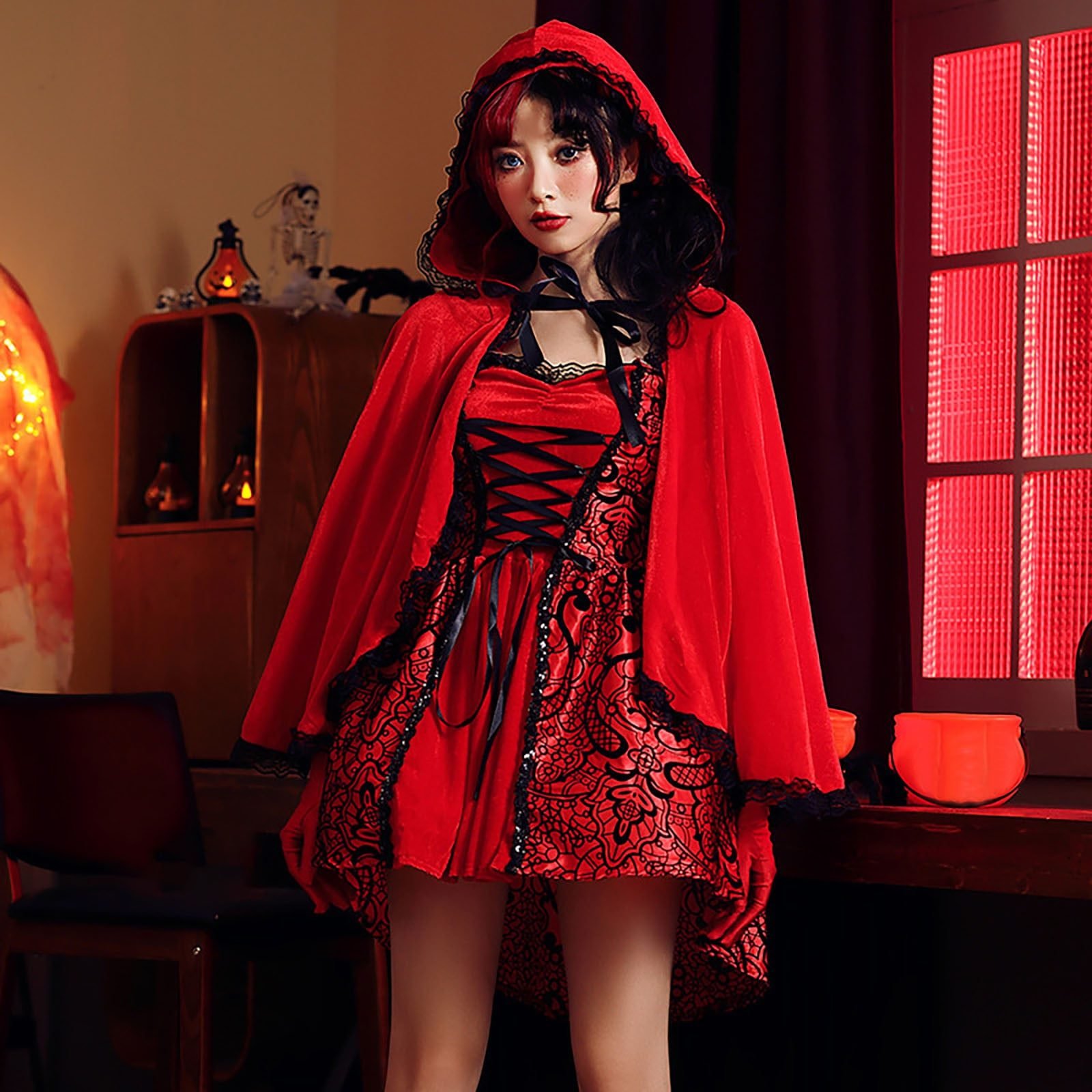 Woman in an elegant red witch Halloween costume
